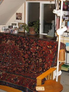 The futon with a Russian rug as a cover, faces the desk and the wall where it used to be.