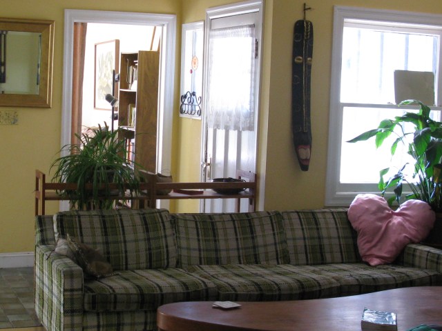 Super long couch creates a physical barrier to the front door.